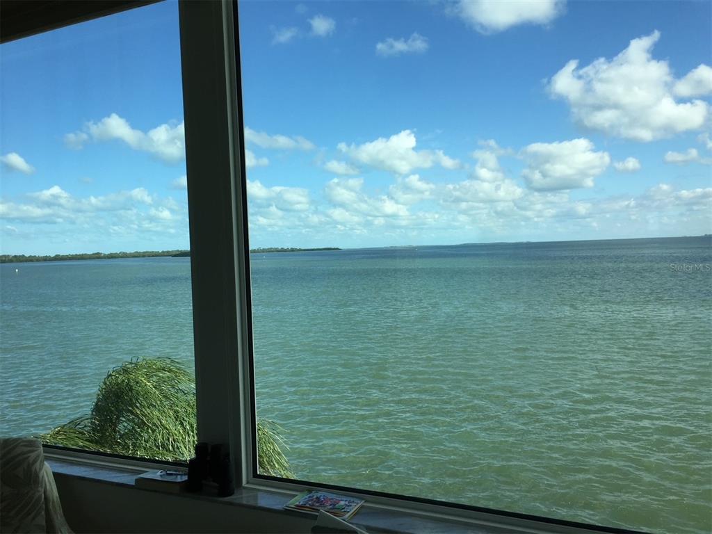 A view of the ocean and sky through a large window in a room — 7 DUNOON PLACE UNIT 303, DUNEDIN, FL