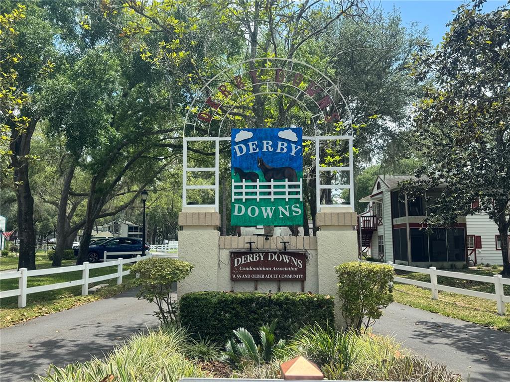 A sign for Derby Downs, a 55 and older condominium community, stands at the entrance — 7817 MIDWAY DRIVE TERRACE UNIT A 103, OCALA, FL