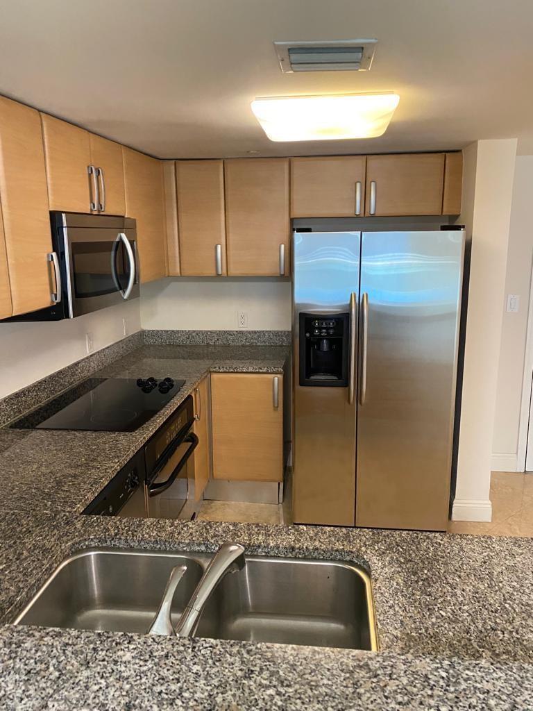 A kitchen featuring light wood cabinets, granite countertops, stainless steel appliances, and a double sink — 2101 Brickell Avenue # 504, Miami FL 33129, MIAMI, FL