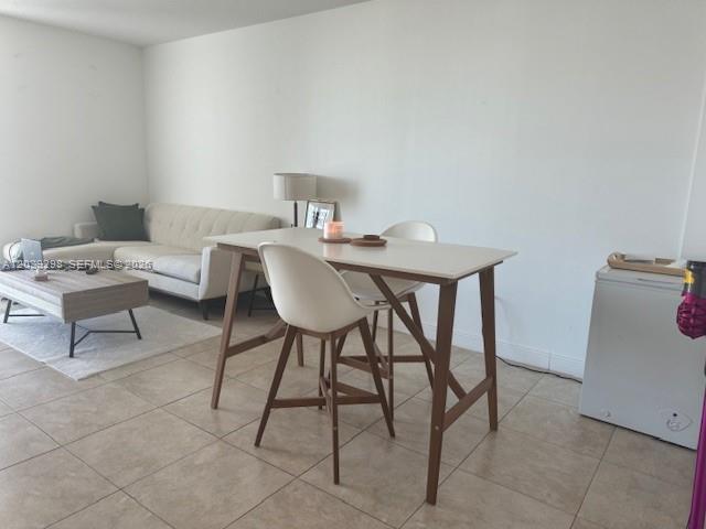 A living room features a beige sofa, a wooden coffee table, and a dining set — 1250 S Miami Ave # 1607, Miami FL 33130, MIAMI, FL