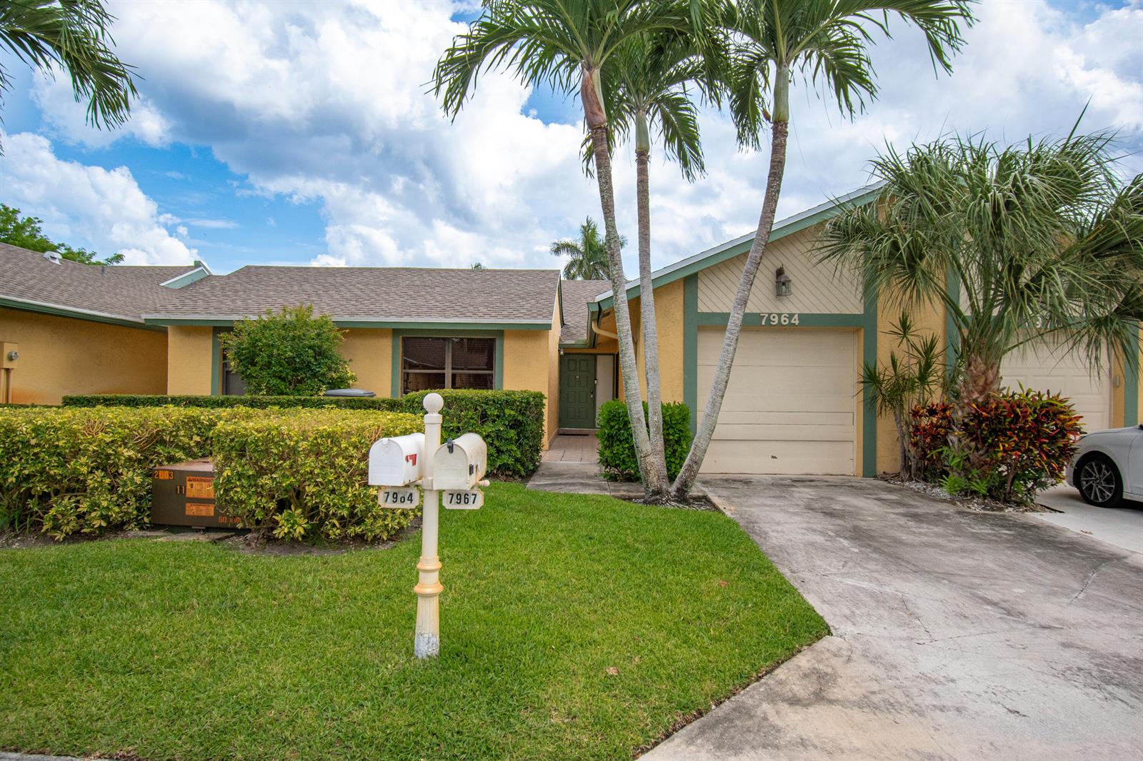 A single-story house with a beige stucco exterior, a garage, and a shared mailbox in front — 7964 Little Lane, Boca Raton FL 33433, BOCA RATON, FL