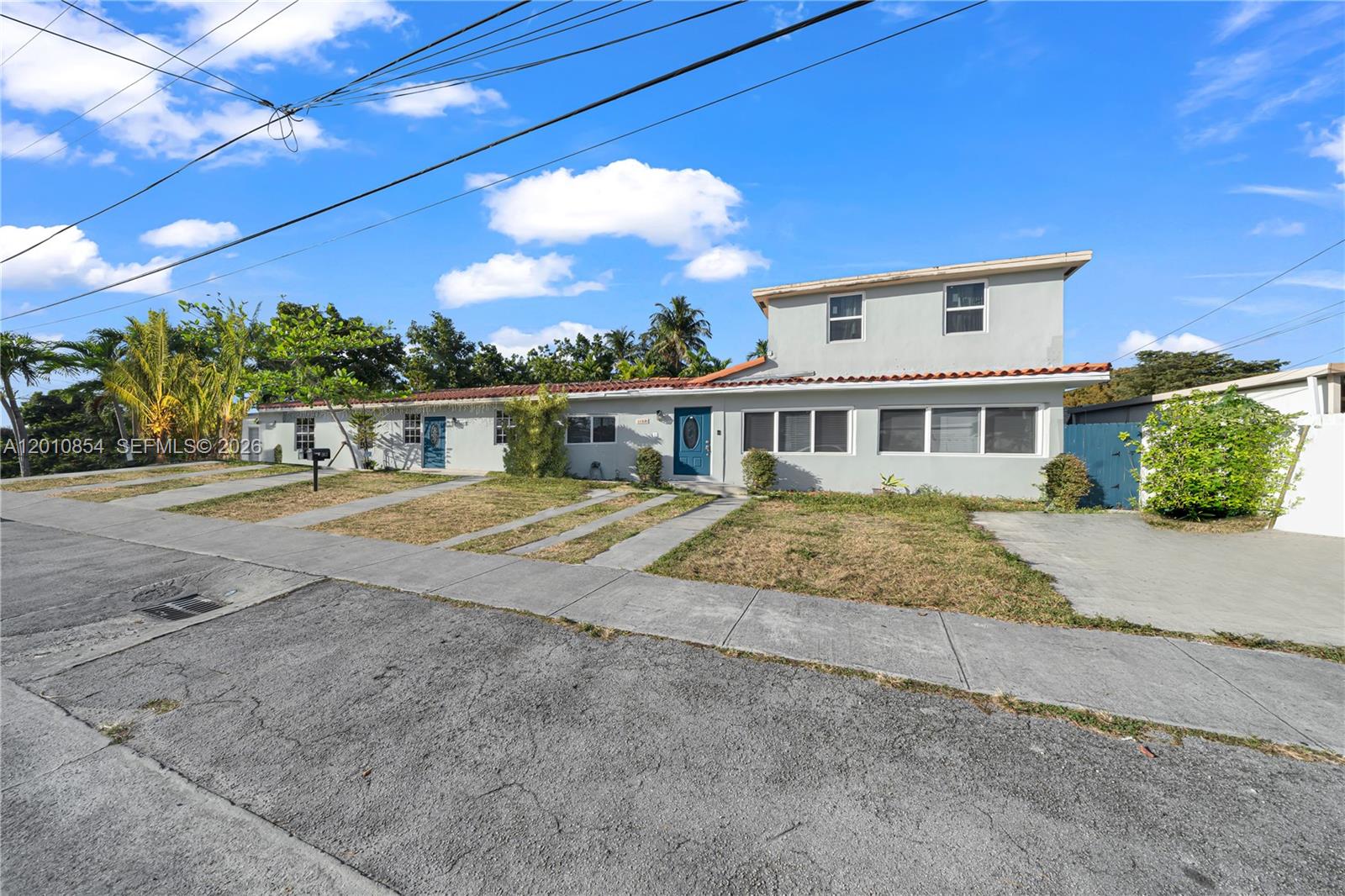 A two-story house with a gray exterior, a tiled roof, and a front lawn — 11021 SW 4th St, Sweetwater FL 33174, SWEETWATER, FL