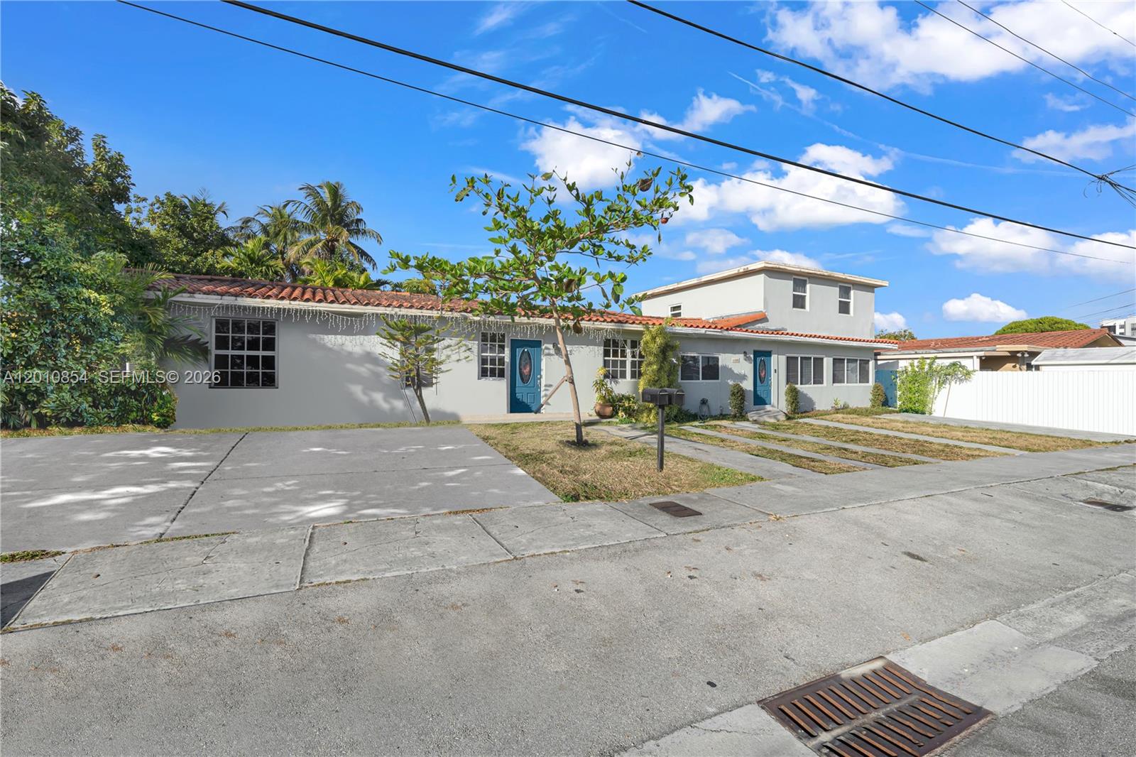 A single-story house with a two-story addition, a tiled roof, and a concrete driveway — 11021 SW 4th St, Sweetwater FL 33174, SWEETWATER, FL
