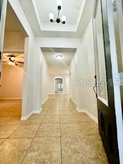 A tiled entryway leads to a hallway with recessed lighting and a decorative chandelier — 8107 NORTHLAKE PARKWAY, ORLANDO, FL