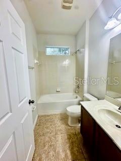 A bathroom features a white vanity, a toilet, and a shower-tub combination with tile flooring — 8107 NORTHLAKE PARKWAY, ORLANDO, FL