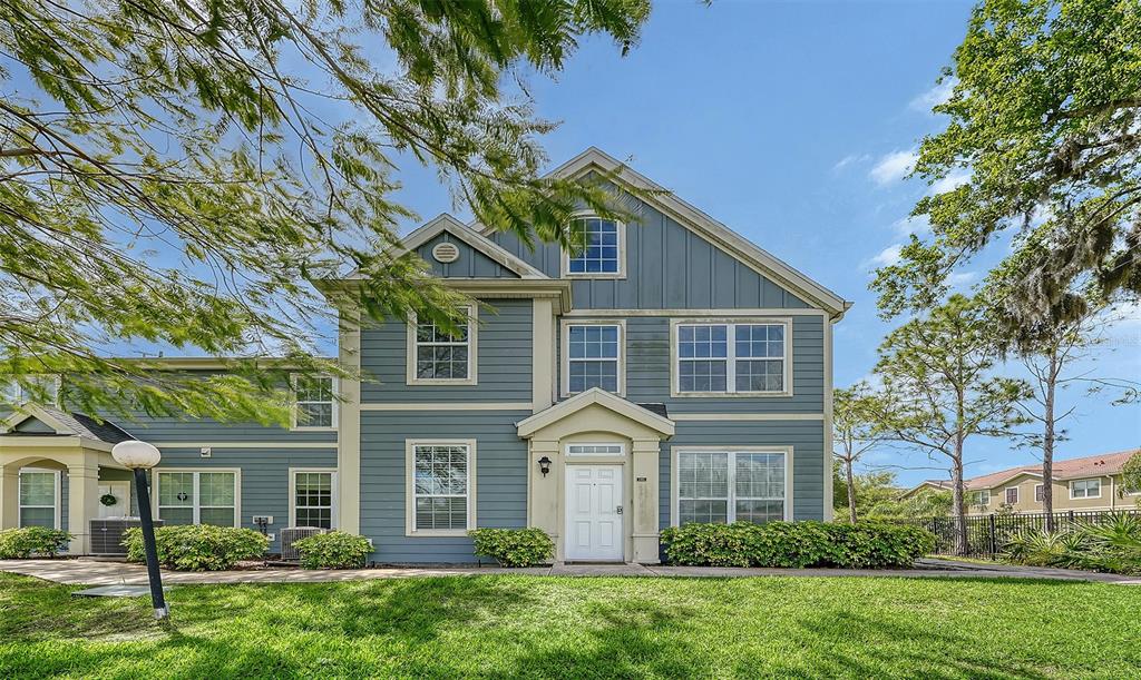 A two-story blue house with a white front door and a green lawn — 5501 ROSEHILL ROAD UNIT 105, SARASOTA, FL