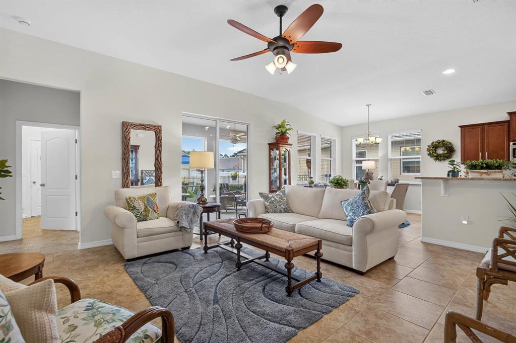 A living room with tile floors, a ceiling fan, and a beige sofa — 3451 PONETA AVENUE, NEW SMYRNA BEACH, FL