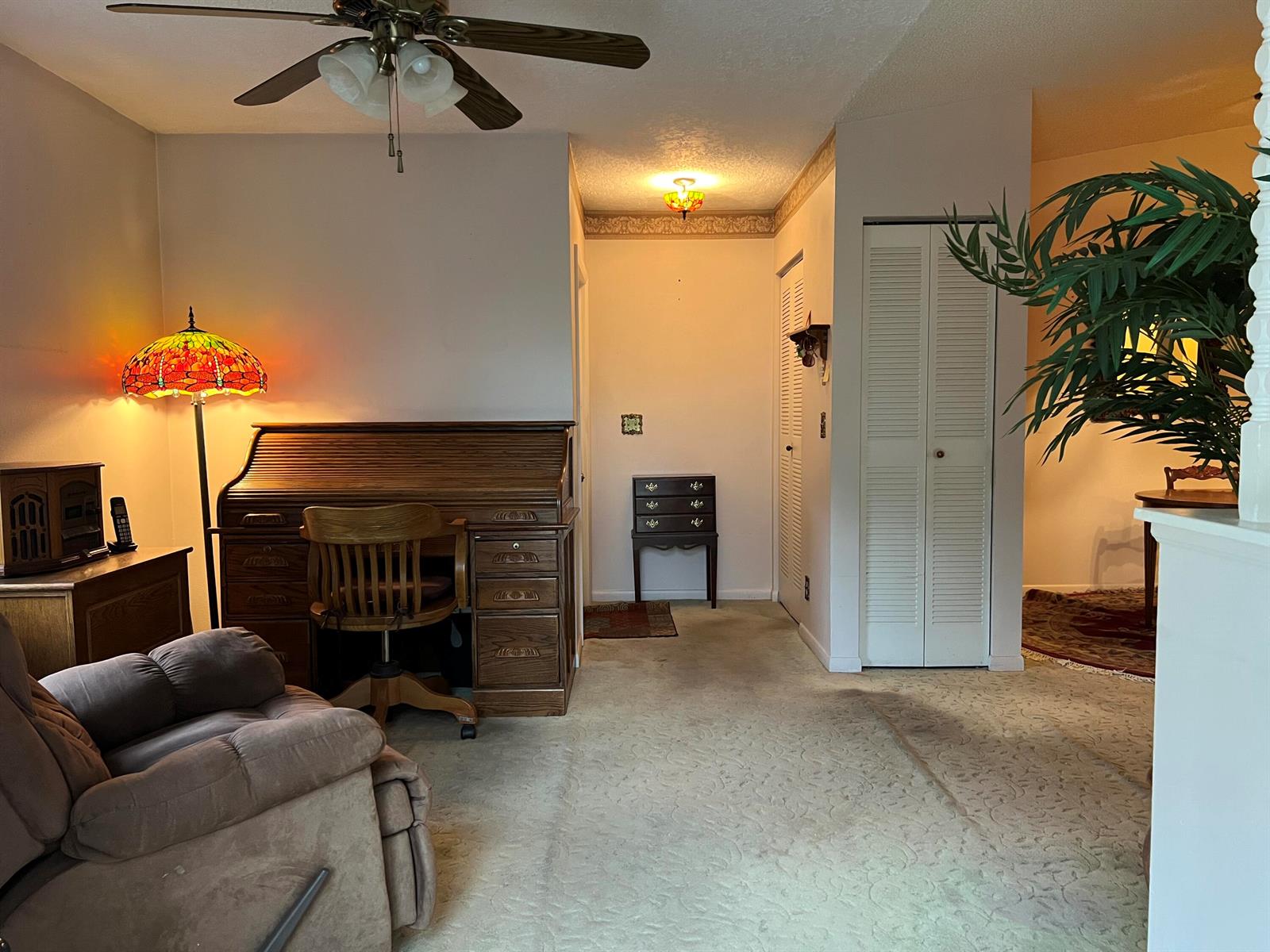 A room featuring a roll-top desk, a recliner, a floor lamp, and a ceiling fan — 3780 Lace Vine Lane # 131, Boynton Beach FL 33436, BOYNTON BEACH, FL