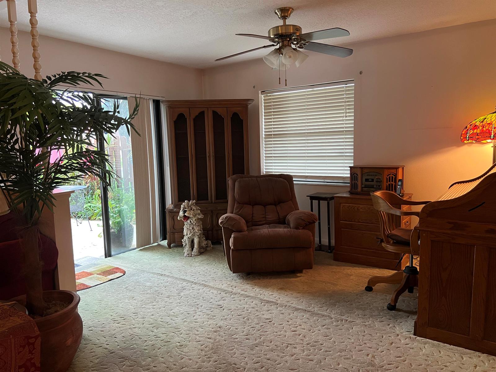 A room features a brown recliner, a wooden desk, a ceiling fan, and a sliding door — 3780 Lace Vine Lane # 131, Boynton Beach FL 33436, BOYNTON BEACH, FL