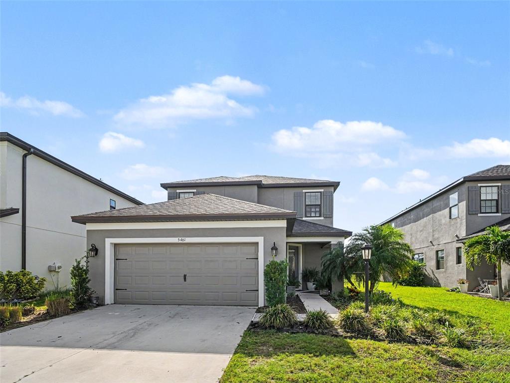 A two-story gray house features a two-car garage and a front walkway — 5461 SUMMIT GLEN, BRADENTON, FL