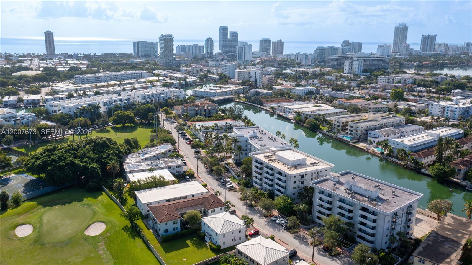An aerial view shows a canal winding through a residential area with apartment buildings — 110 S Shore Dr # 5B, Miami Beach FL 33141, MIAMI BEACH, FL