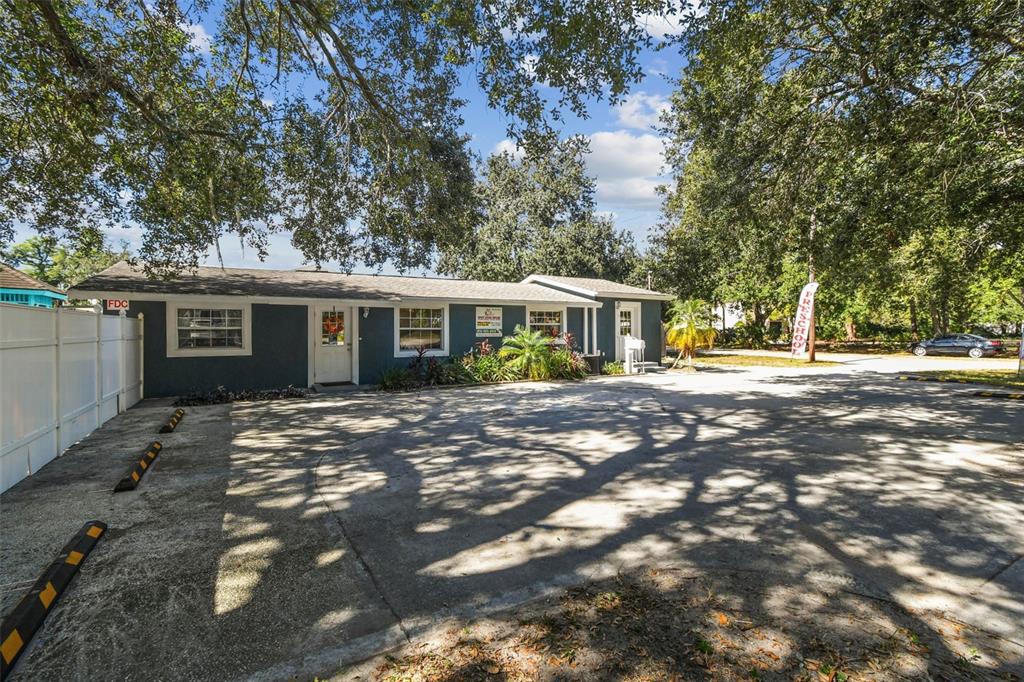 A single-story gray building with a parking lot and a preschool sign in the front — 9912 N MYRTLE STREET, TAMPA, FL