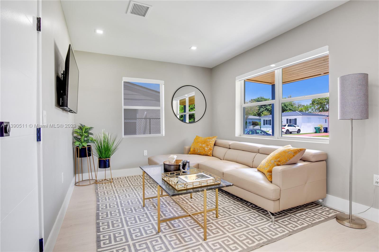 A living room features a beige sectional sofa, a geometric rug, and a floor lamp — 6428 SW 23rd St # 6428, Miami FL 33155, MIAMI, FL