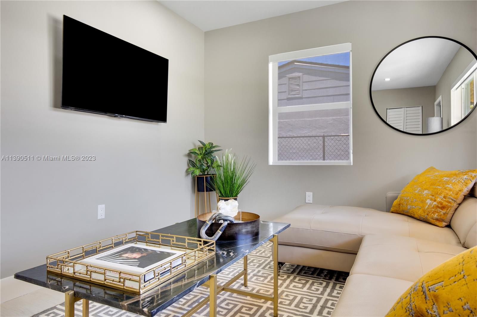 A living room features a beige sectional sofa, a marble coffee table, and a wall-mounted television — 6428 SW 23rd St # 6428, Miami FL 33155, MIAMI, FL