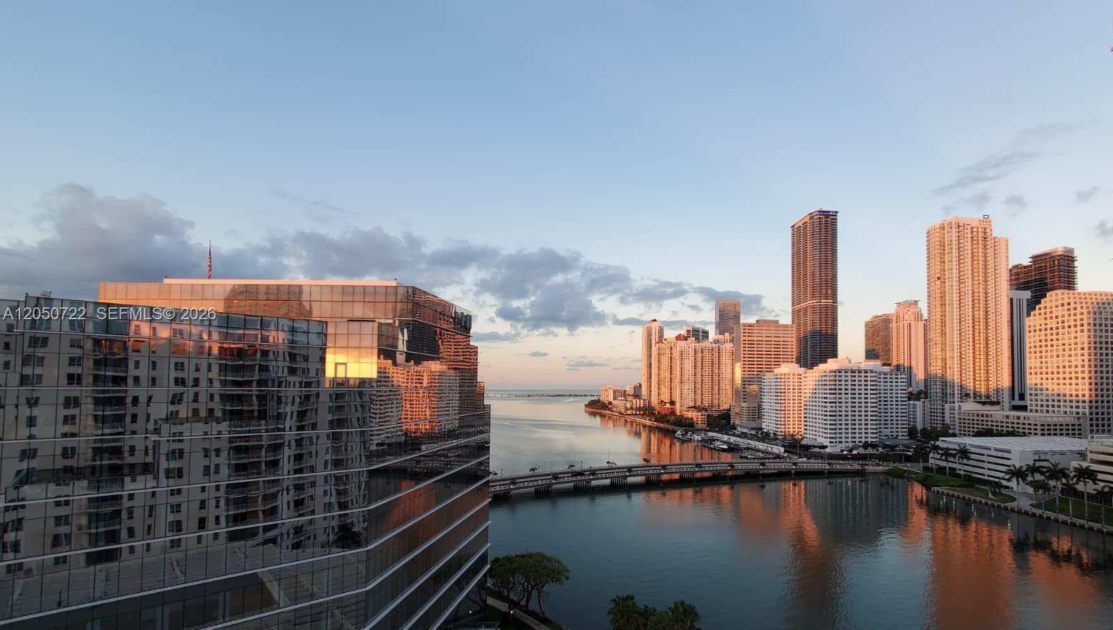 A view of a city skyline and a bridge over water at sunset — 701 Brickell Key Blvd # 1611, Miami FL 33131, MIAMI, FL