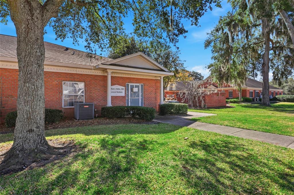 A brick dental office building with a covered entrance and a sidewalk on a lawn — 4130 NW 37TH PLACE Ste E, GAINESVILLE, FL