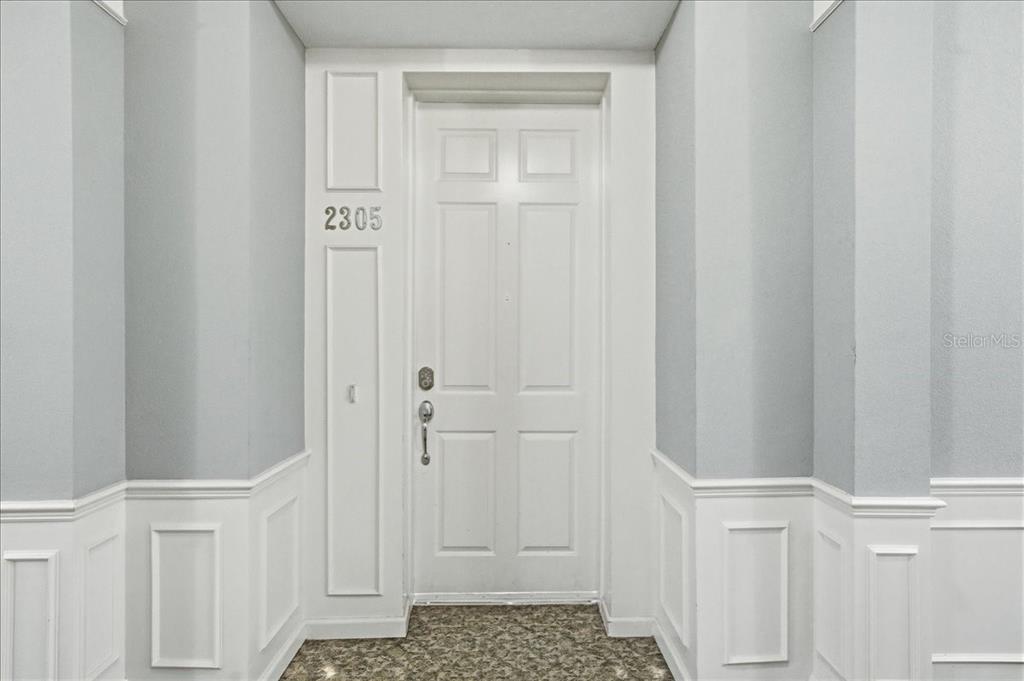 A white front door with the number 2305 is set in a recessed entryway — 7903 SEMINOLE BOULEVARD UNIT 2305, SEMINOLE, FL