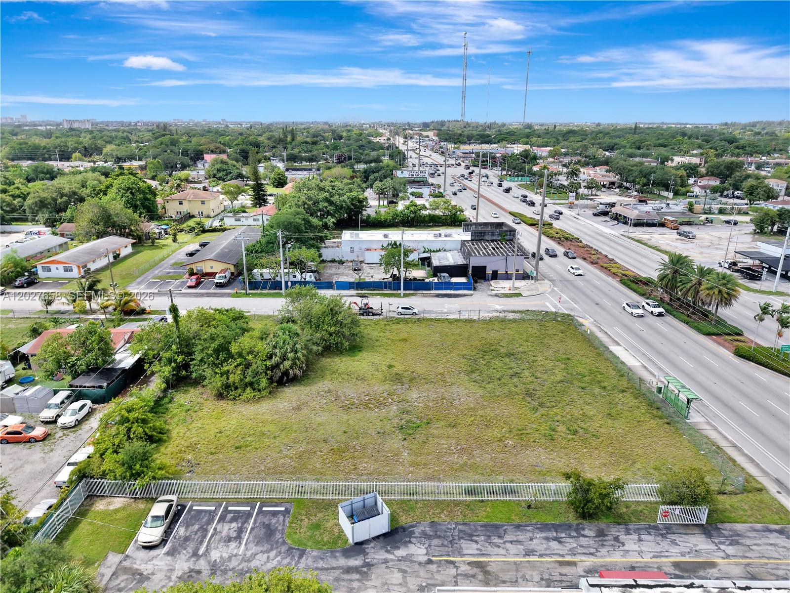 An aerial view shows a vacant, fenced-in grass lot adjacent to a multi-lane road — 2591 S State Road 7 Rd, West Park FL 33023, WEST PARK, FL