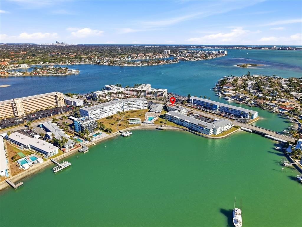 An aerial view shows waterfront condominium buildings and a bridge surrounded by a bay — 1898 SHORE DRIVE S UNIT 319, SOUTH PASADENA, FL