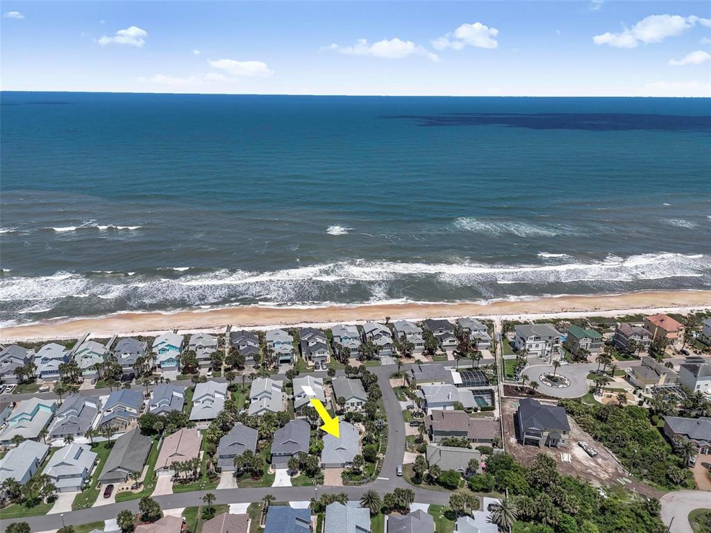 An aerial view shows a residential neighborhood located directly along the oceanfront — 15 SEA VISTA DRIVE, PALM COAST, FL