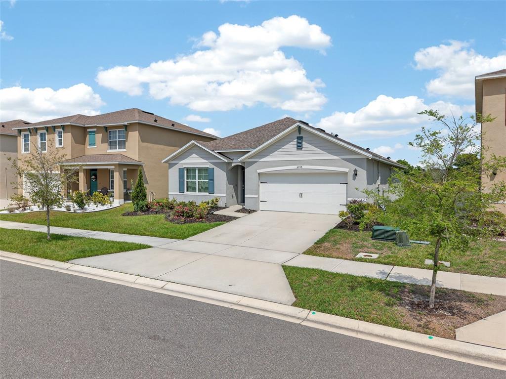 A single-story gray house with a two-car garage and a concrete driveway — 5740 GREY GRANITE WAY, LAKELAND, FL