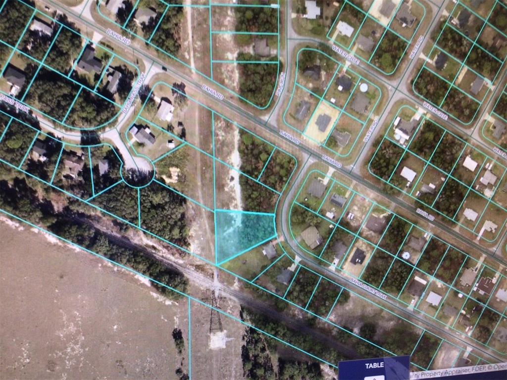An aerial map view showing a highlighted vacant lot situated near a road and trees — 0 BAHIA COURT TRACK, OCALA, FL