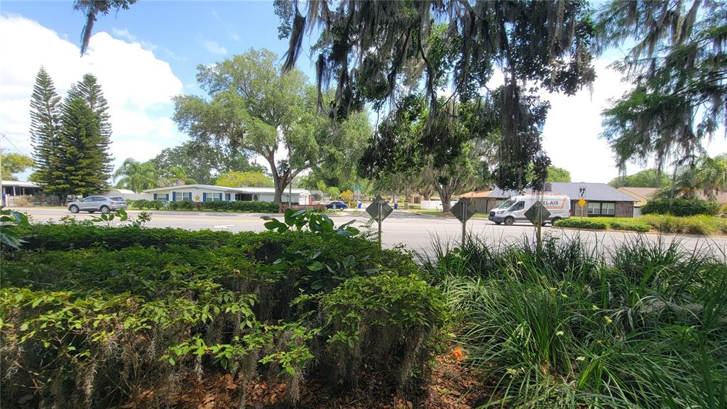 A street view shows a road with a van, a car, and surrounding trees and houses — NEPTUNE ROAD, KISSIMMEE, FL