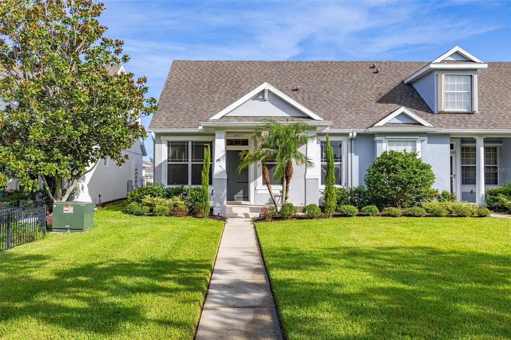 A single-story house with a gray exterior, a front walkway, and a manicured lawn — 14623 SWEET ACACIA DRIVE, ORLANDO, FL