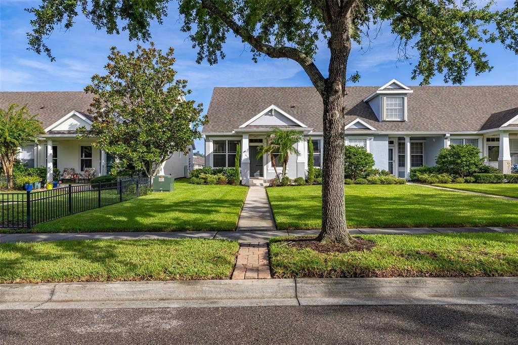 A single-story house with a gray exterior, a front walkway, and a large tree — 14623 SWEET ACACIA DRIVE, ORLANDO, FL
