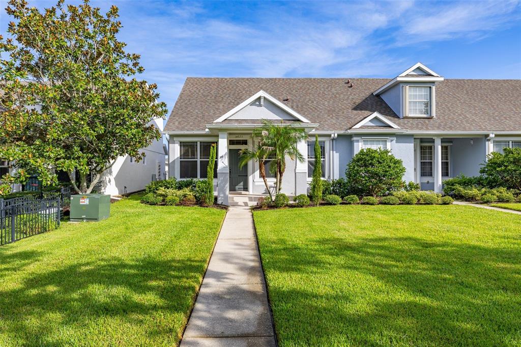 A single-story house with a gray exterior, a front walkway, and a manicured lawn — 14623 SWEET ACACIA DRIVE, ORLANDO, FL