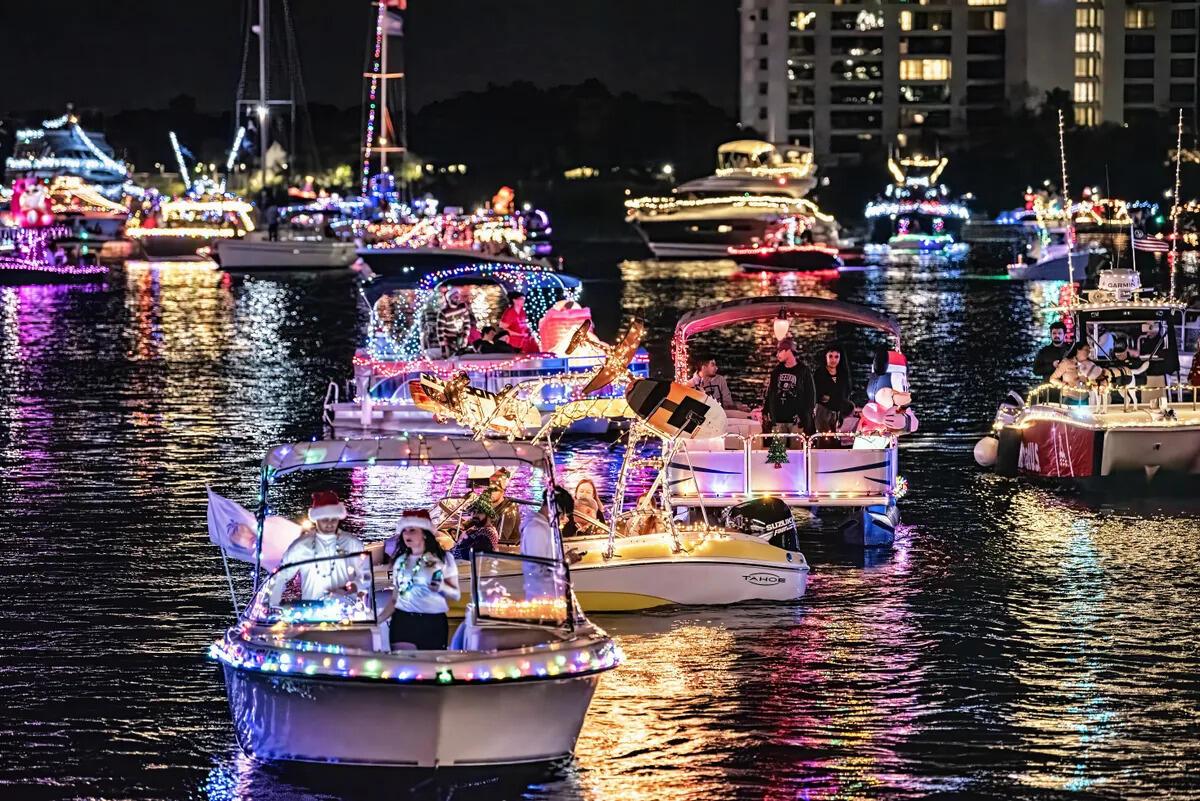 Multiple boats decorated with Christmas lights float on a dark body of water at night — 1401 N Riverside Drive N # 307, Pompano Beach FL 33062, POMPANO BEACH, FL