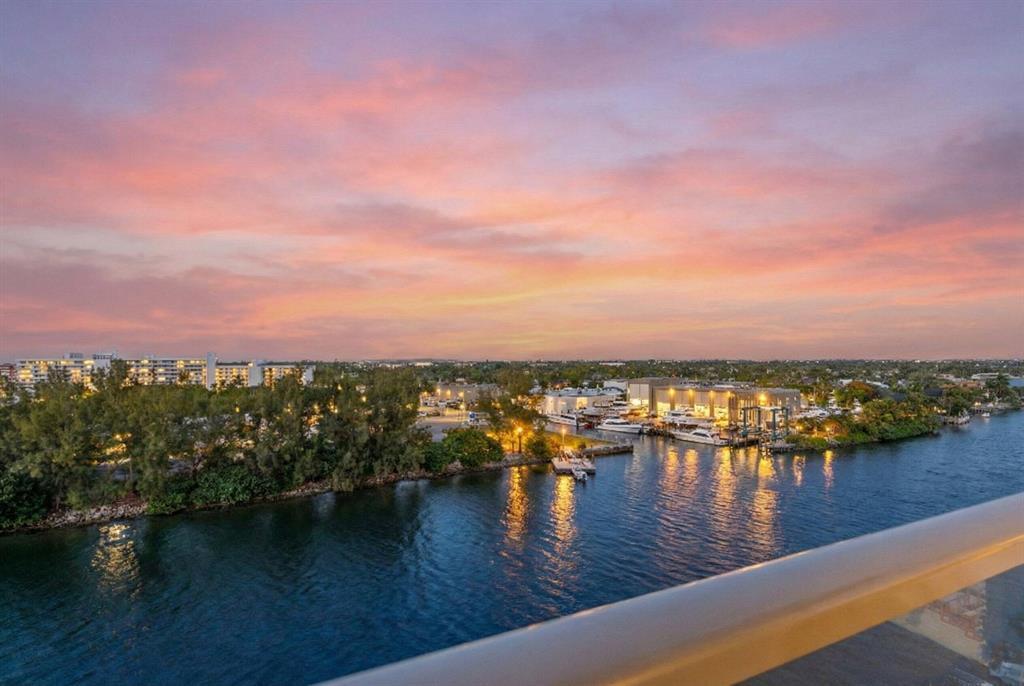 An elevated view of a waterfront marina at sunset with boats docked near buildings — 1401 N Riverside Drive N # 307, Pompano Beach FL 33062, POMPANO BEACH, FL