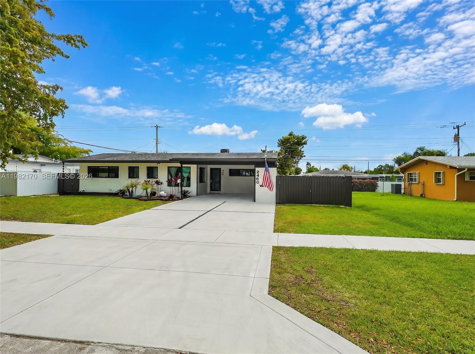 A single-story house with a white exterior, a covered entryway, and a concrete driveway — 9460 Martinique Dr, Cutler Bay FL 33189, CUTLER BAY, FL