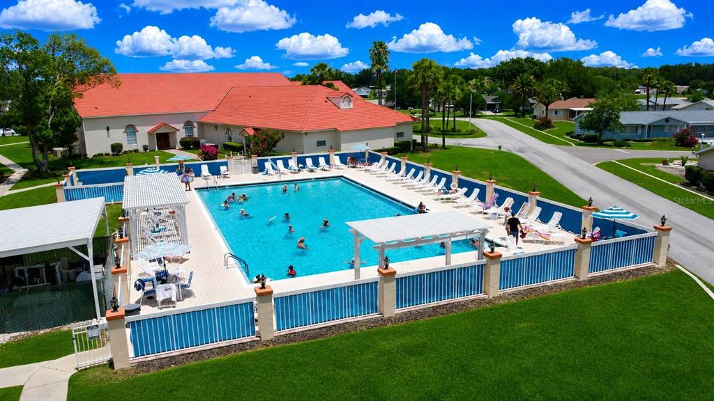 An aerial view of a white house with a screened-in porch and a large palm tree — 9900 SE 175TH PLACE, SUMMERFIELD, FL