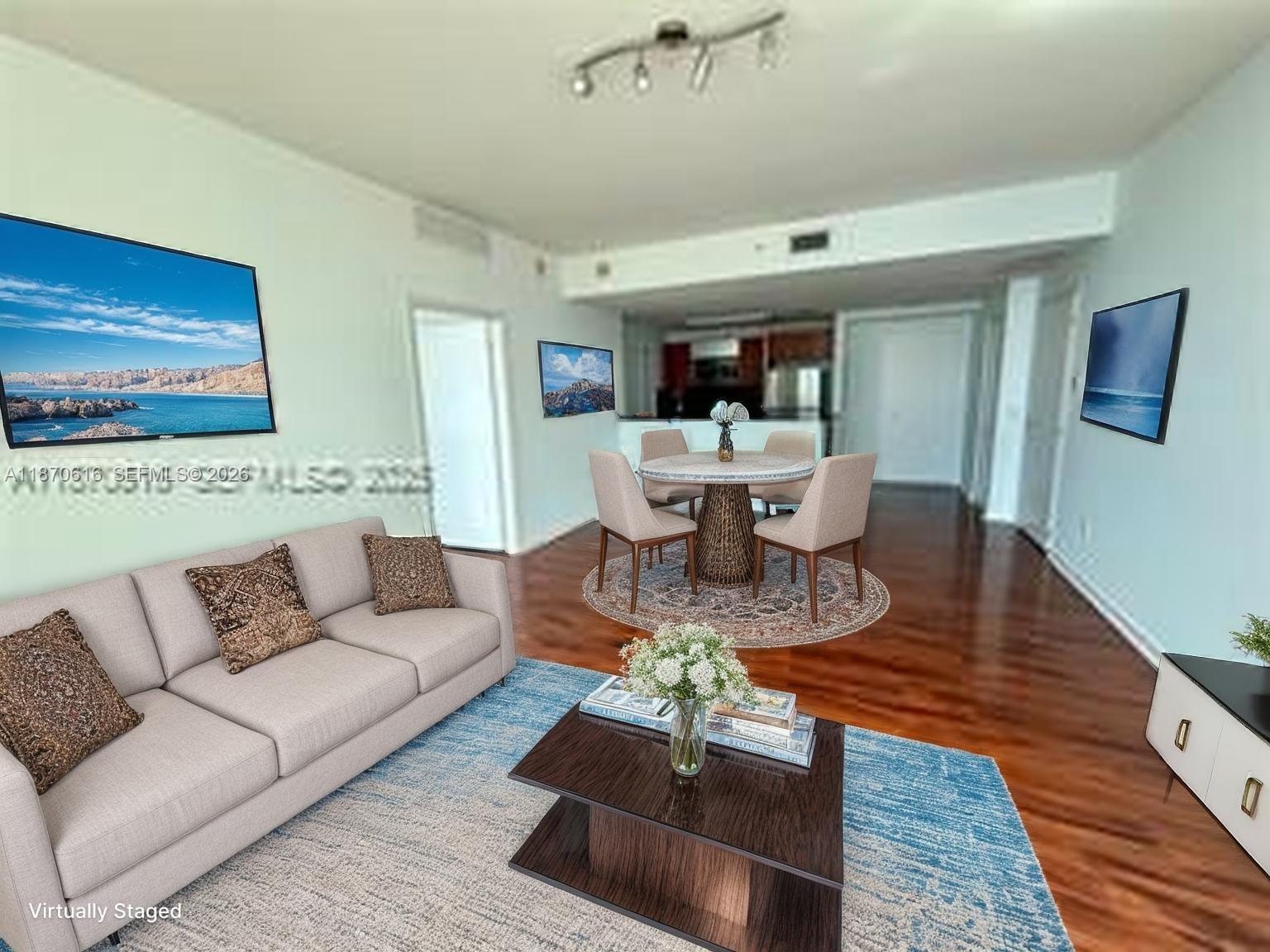 This virtually staged living and dining area features hardwood floors, light walls, and modern furniture — 300 S Biscayne Blvd # 3014, Miami FL 33131, MIAMI, FL