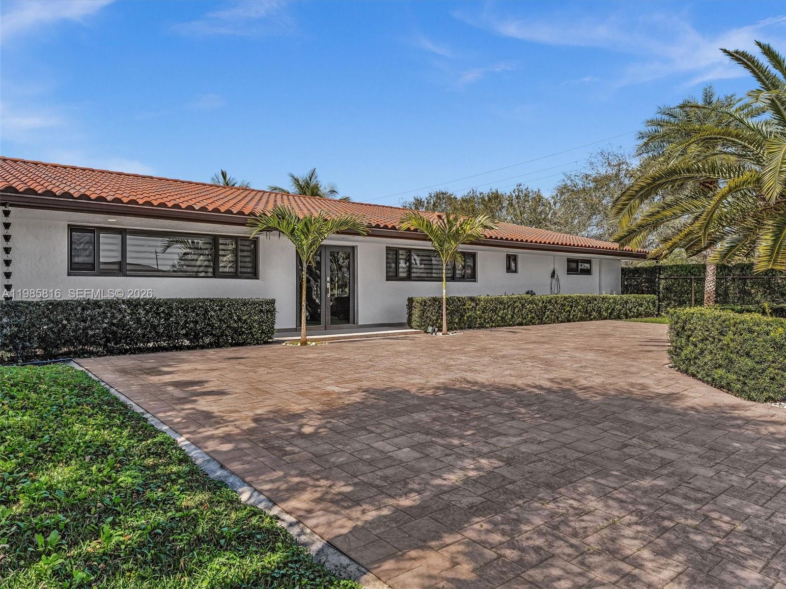 A single-story house with a terracotta tile roof and a large paved driveway — 4501 SW 133rd Ave, Southwest Ranches FL 33330, SOUTHWEST RANCHES, FL