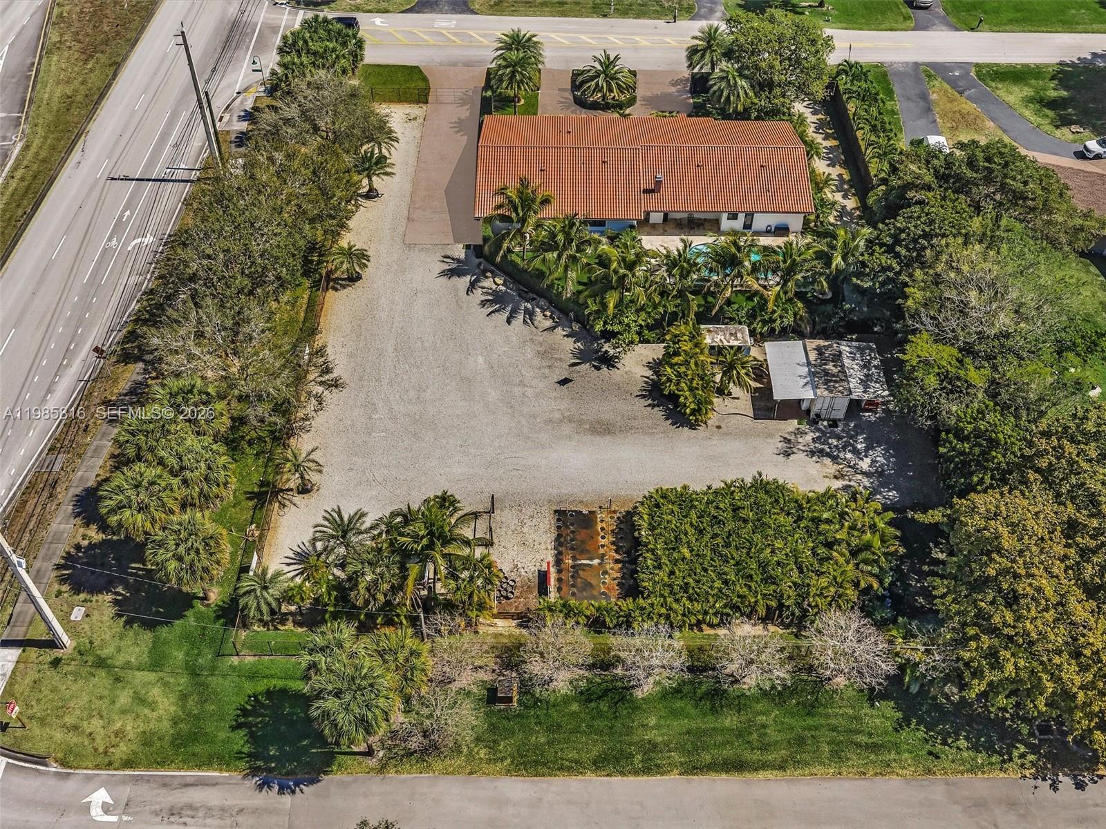 An aerial view shows a house with a red tile roof, pool, and large gravel lot — 4501 SW 133rd Ave, Southwest Ranches FL 33330, SOUTHWEST RANCHES, FL