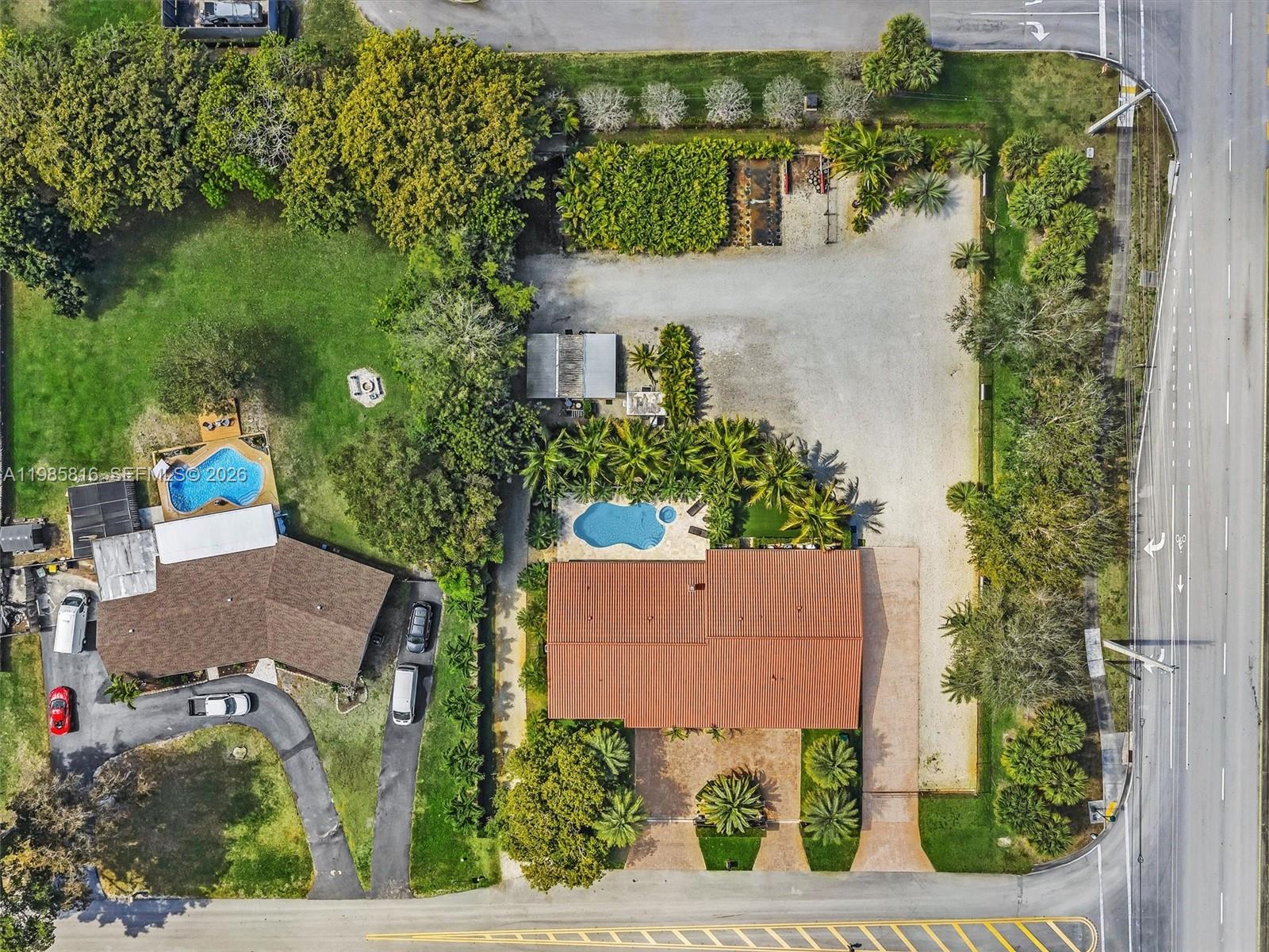 An aerial view shows two residential properties with swimming pools, large yards, and gravel driveways — 4501 SW 133rd Ave, Southwest Ranches FL 33330, SOUTHWEST RANCHES, FL
