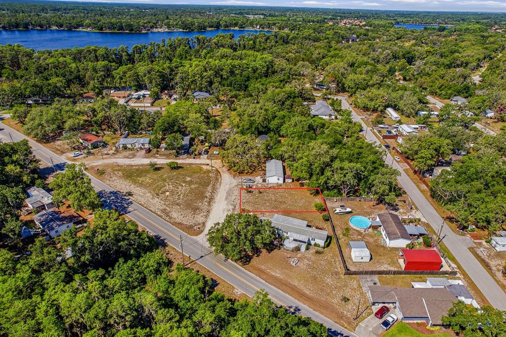 An aerial view shows a rectangular vacant lot outlined in red within a residential neighborhood — CODEL LOOP, NEW PORT RICHEY, FL