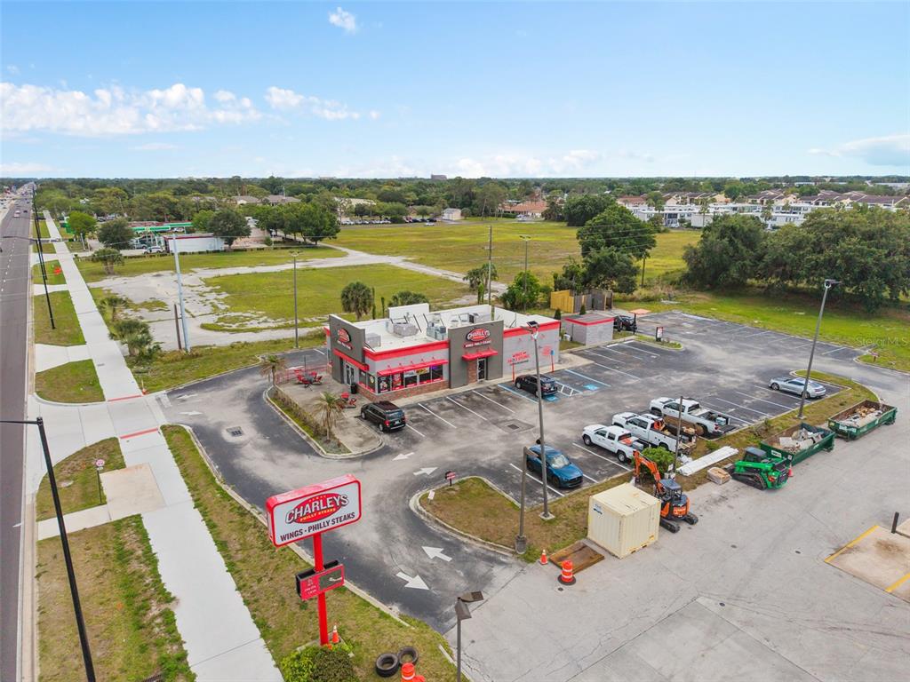 An aerial view shows a Charleys Philly Steaks restaurant with a parking lot and signage — 3250 W VINE STREET, KISSIMMEE, FL