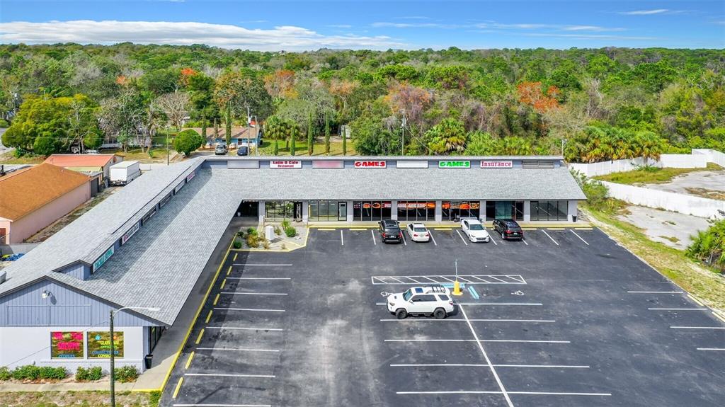 An aerial view of a single-story commercial strip mall with a parking lot — 15215 US HIGHWAY 19 UNIT A, HUDSON, FL