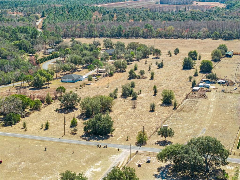 An aerial view shows a rural property with a house, outbuildings, and scattered trees — GREEN SWAMP ROAD, CLERMONT, FL