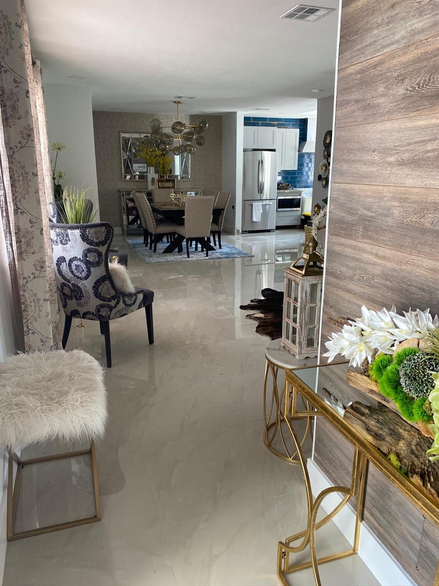 A view from a foyer looking into a dining area and kitchen with tiled floors — 7913 Kismet Street, Miramar FL 33023, MIRAMAR, FL
