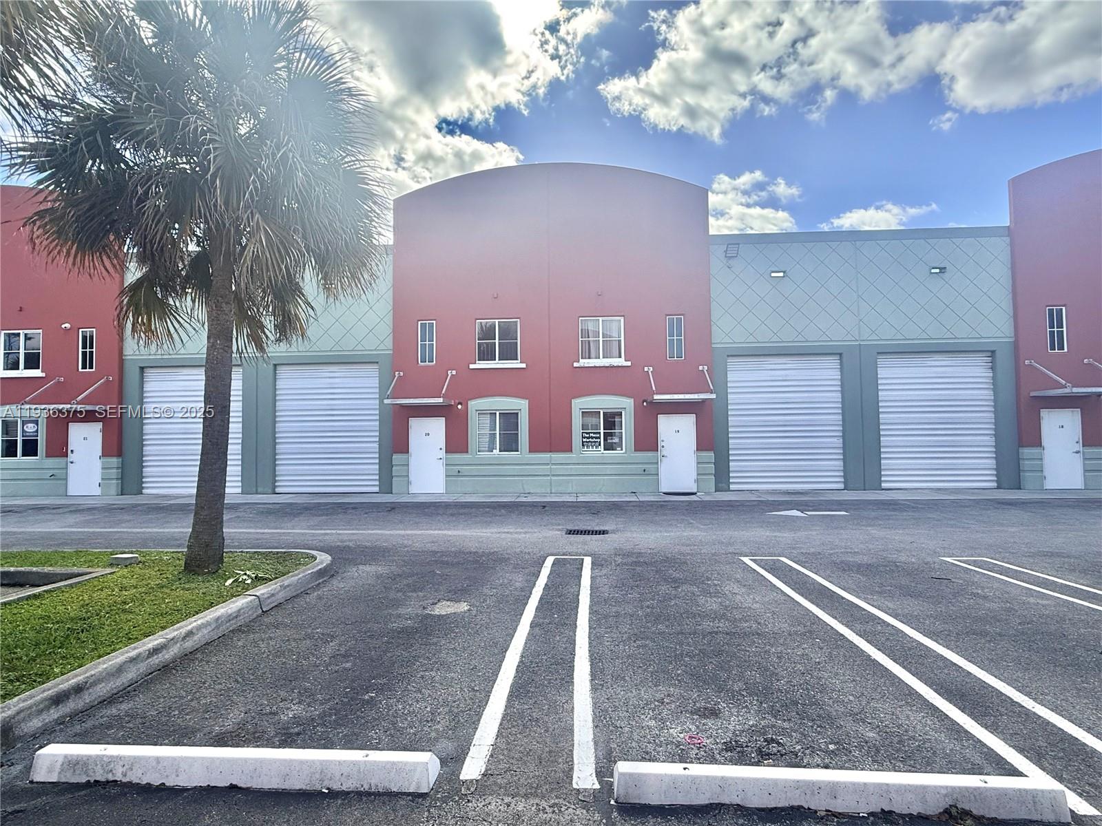 A row of commercial warehouse units with roll-up doors and white entry doors — 12491 SW 134th Ct # 20, Miami FL 33186, MIAMI, FL