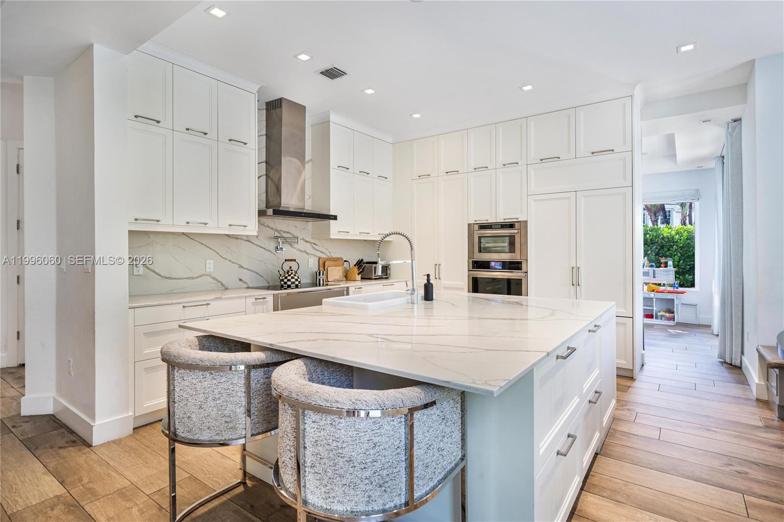 A white two-story house features a swimming pool and patio in a landscaped backyard — 3703 NE 199th St, Aventura FL 33180, AVENTURA, FL