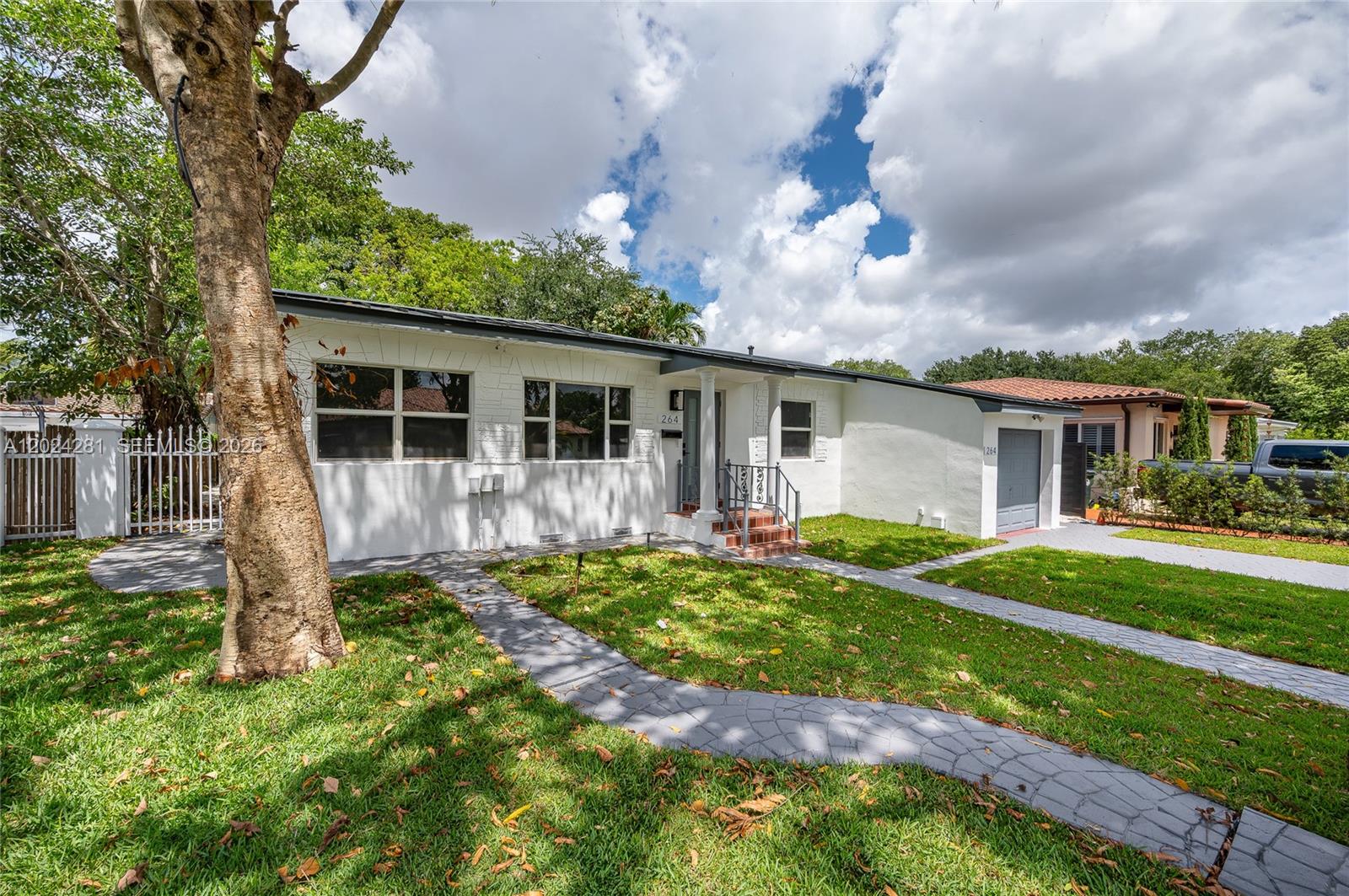 A single-story white house with a gray roof, a small garage, and a paved walkway — 264 Navajo St, Miami Springs FL 33166, MIAMI SPRINGS, FL