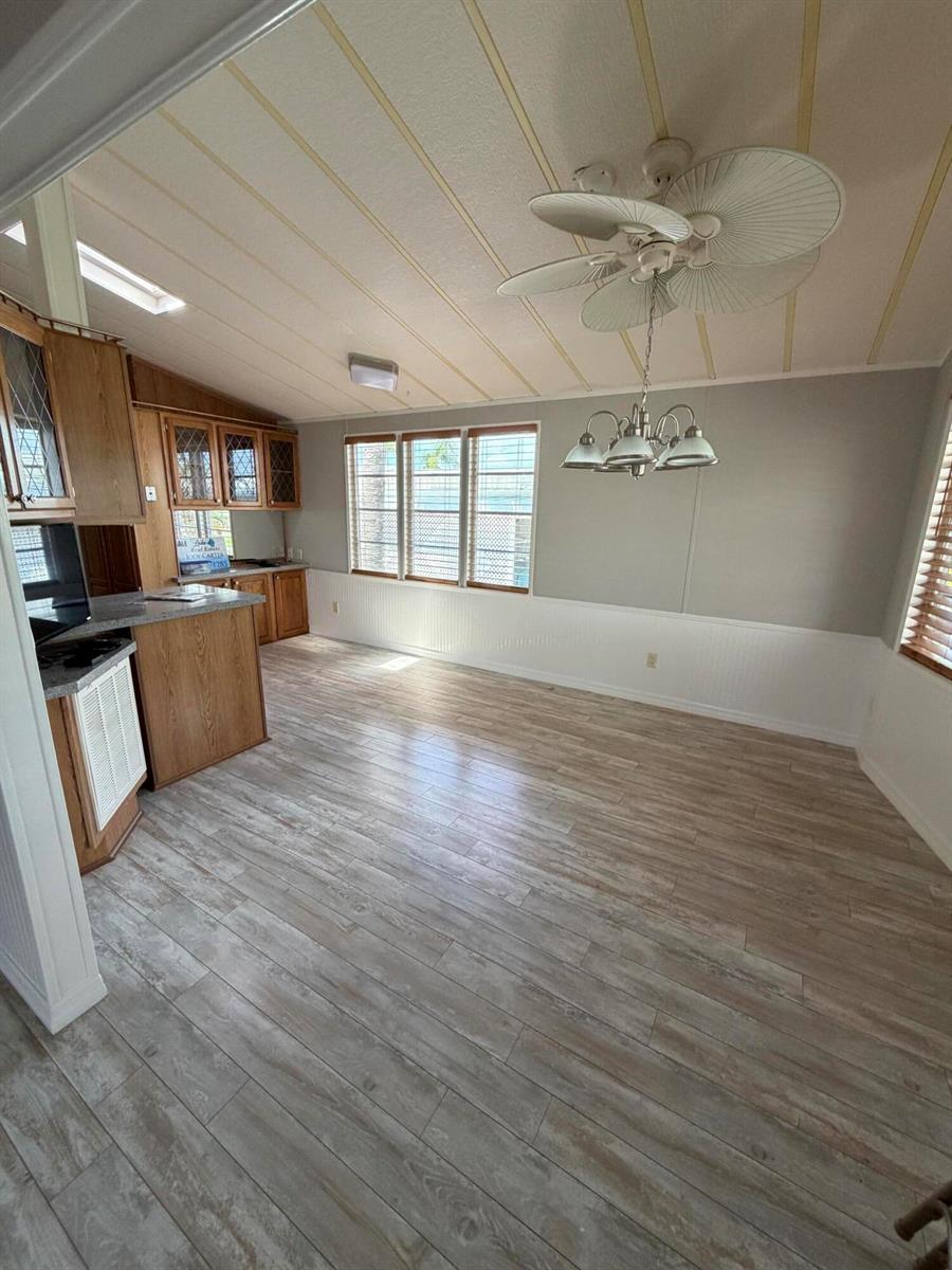 A dining area with wood-look flooring, a ceiling fan, and a kitchen peninsula — 5367 SE 66th Avenue, Okeechobee FL 34974, OKEECHOBEE, FL