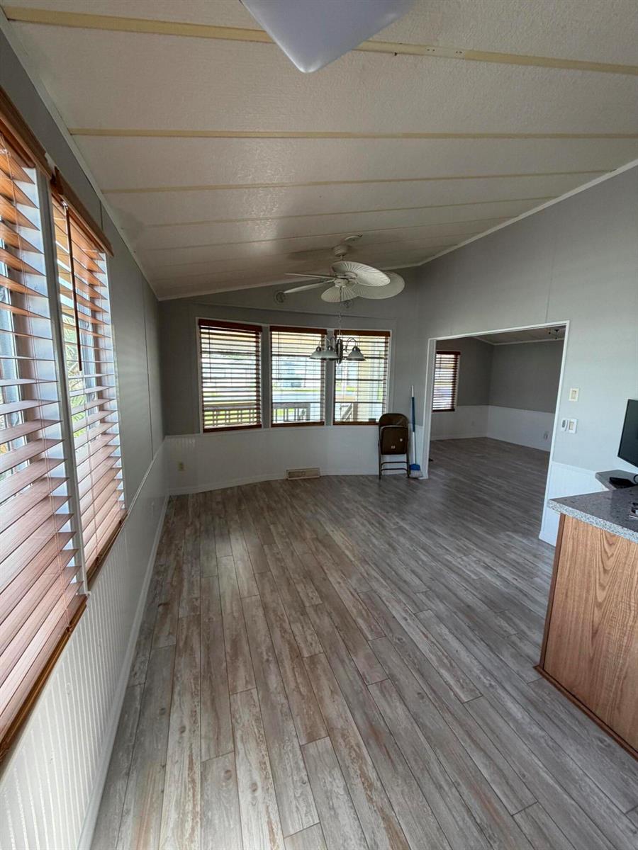 A dining area with wood-look flooring, light gray walls, and windows with wooden blinds — 5367 SE 66th Avenue, Okeechobee FL 34974, OKEECHOBEE, FL