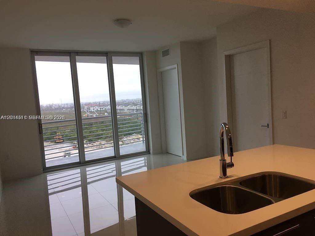 A modern bathroom features a double-sink vanity with dark wood cabinets and white countertops — 7875 NW 107th Ave # 617, Doral FL 33178, DORAL, FL