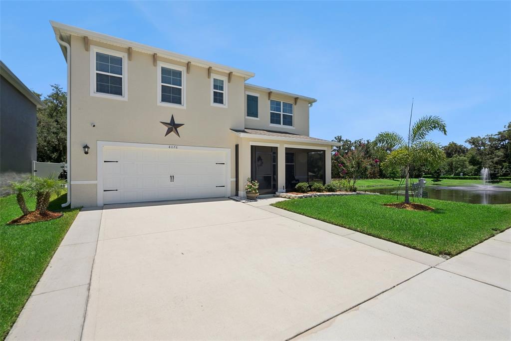 A two-story house with a two-car garage, a star decoration, and a screened-in porch — 4076 SAPSUCKER LOOP, SANFORD, FL